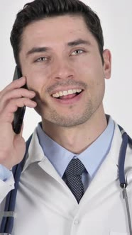 Smiling Doctor Talking on Smartphone in Vertical Video