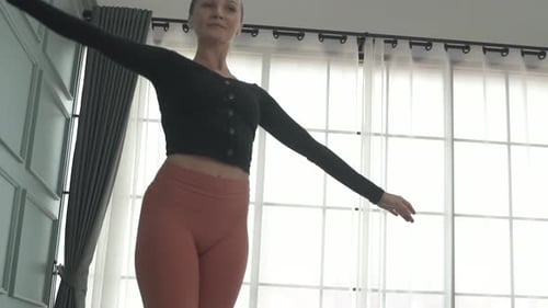 Friends practice ballet dance at studio.