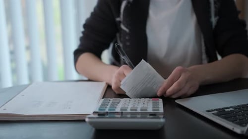 Close Up Footage of Woman Checking Bills Taxes Bank Account Balance and Calculating Expenses in the
