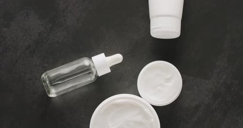 Top View on Cosmetic Products for Skincare on Dark Background