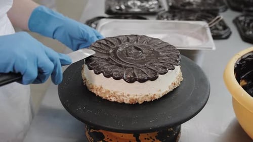 Delicious Chocolate Cake Decoration Pastry Chef Adding Smooth Topping in Professional Bakery