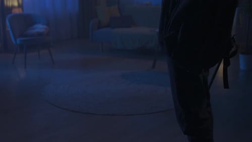 Burglar Enters Dark Home at Night with Flashlight