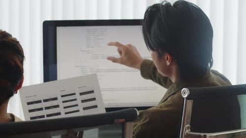 Programmers Discussing Tasks of Software Developing Project at Office