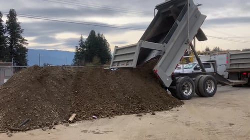 Dump Truck unloading Soil on a Building Site in British Columbia, Canada