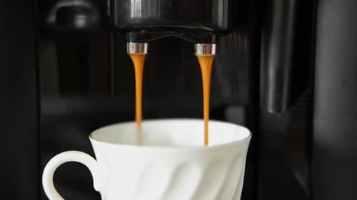 Espresso Machine Dispensing Coffee into White Mug