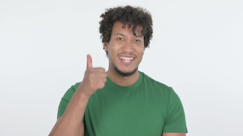 Young Adult Gives Thumbs Up on White Background