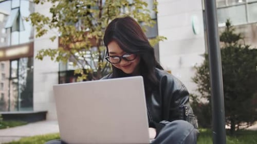 Young Adult Using Laptop in Urban Setting
