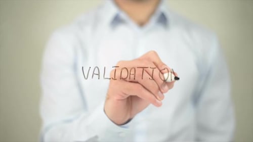 Hand Writes the Word Validation on Glass Surface