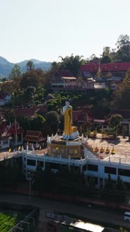Golden Buddha Statue Standing Tall Within Abandoned Buddhist Temple Nestled Amid Serene Mountain