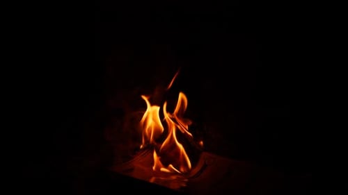 Fire burning a substance in darkness