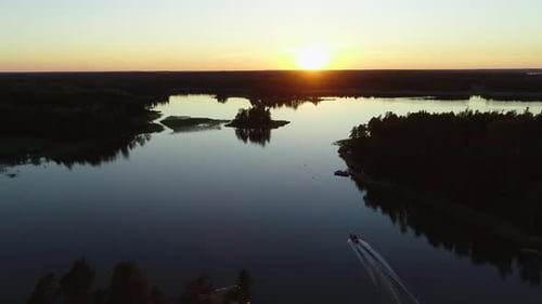 Drone footage of boat driving in beautiful sunset