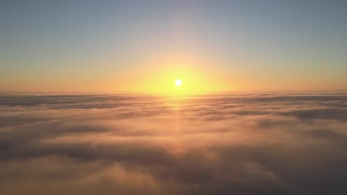 Aerial View of Dreamy Sunrise Above Clouds