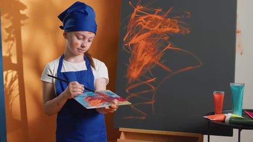 Girl Holding Brush in Art Studio