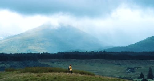 A woman hiking through the mountain for adventure while walking in nature