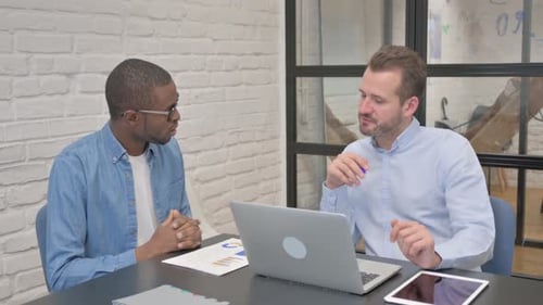 Business People Discussing Project while Sitting in Office