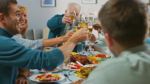 Family toasting at the dinner table together