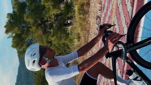 Vertical video of cyclist riding on cycle lane path. Man cycling on bicycle