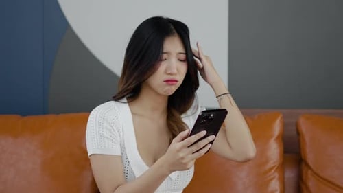 Upset Woman Using Her Mobile Phone