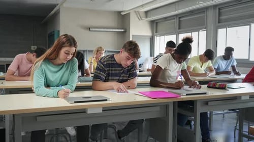 Multi Ethnic Teenager Students Taking Exam at High School Technical Preparation Course for