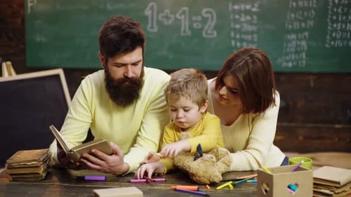 Family Reads Book Together in Classroom Setting