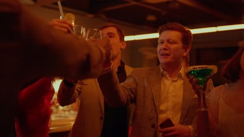 Happy People Group Clinking Glasses in Luxury Restaurant. Cheerful Friends Celebrating Birtay