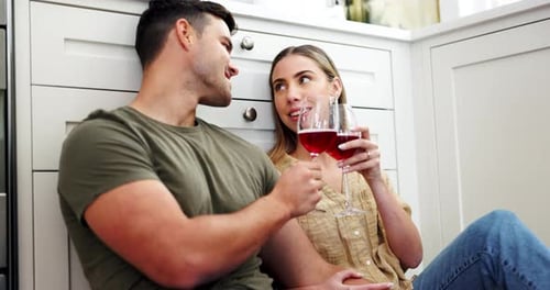 Affectionate Couple Enjoying Wine in Kitchen
