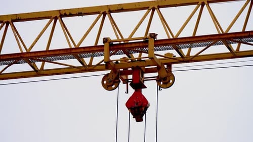 Close Up View of Yellow Crane Movement at Factory Transportation Warehouse Steel