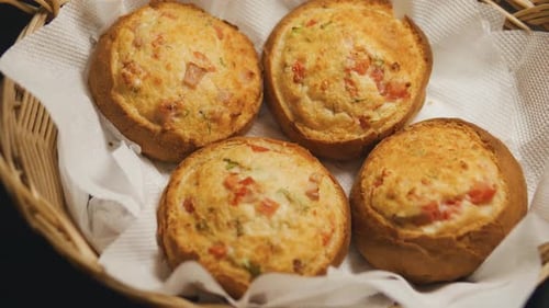 Bacon and Cheese Rolls in a Wicker Basket Close Up