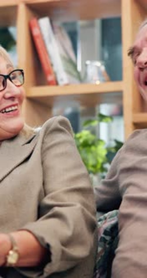 Smiling Senior Couple Close Together Indoors
