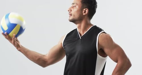 Man Spins Volleyball on Finger in Studio
