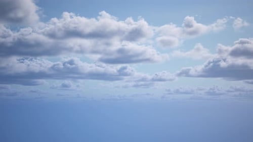Une vue de dessus des nuages se déplaçant lentement dans le ciel