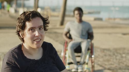 Friends Enjoying the Beach Together in Wheelchairs