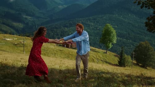Happy Couple Twirling and Running on Mountain Meadow