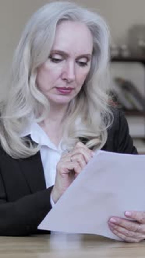 Senior Businesswoman Reading Contract, Vertical Video