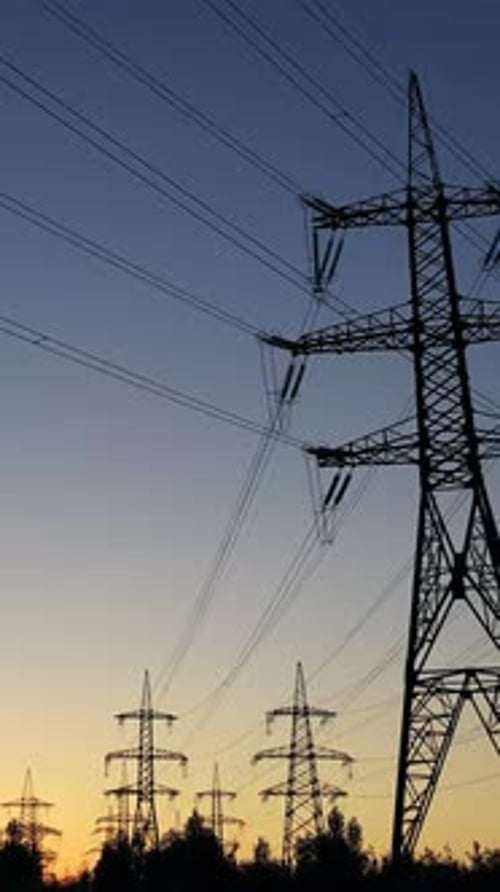Electrical Pylons Silhouetted Against a Colorful Sky