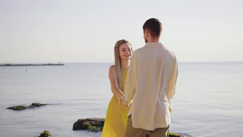 A Romantic Couple Holds Hands on a Beautiful Beach During a Stunning Sunset Their Connection