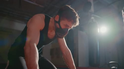 Muscular Man Rests Masked Breathing Heavily