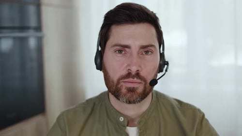 Man Wearing Headset During a Video Call