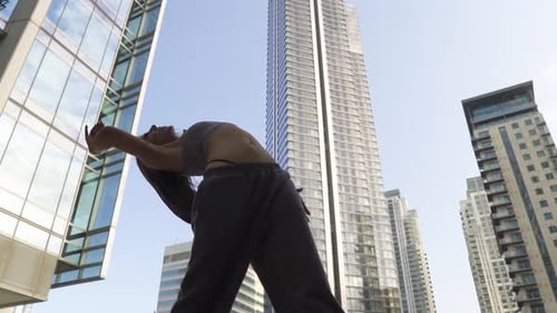 Versatile young female hip hop street dancer full of energy performing her moves surrounded by massi