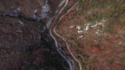 Aerial View of a Autumn Forest Through Which a Winding Road Passes in the Mountains