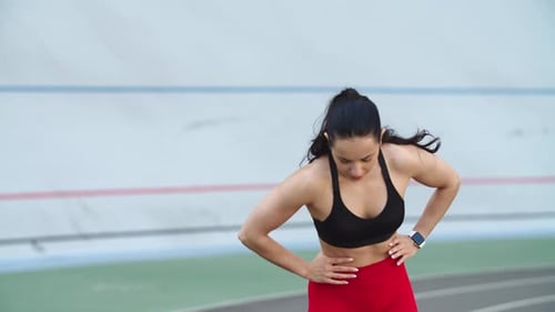 Tired Sport Woman Running on Racetrack. Portrait of Exhausted Woman Running On