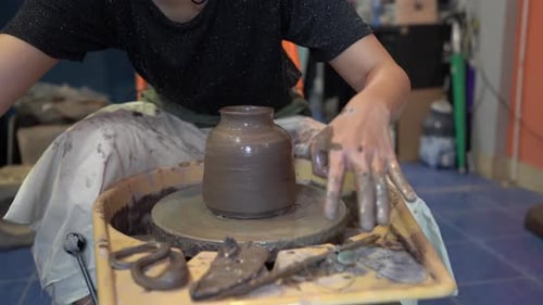 People Creating Pottery in Studio. Female artisan creating handmade ceramics in pottery workshop