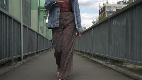 Fashionable Woman Walking and Removing Jacket