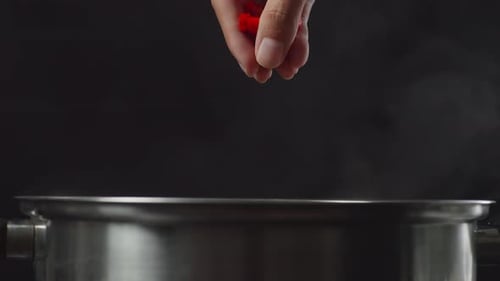 Adding Red Pepper Flakes to a Boiling Pot