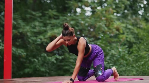 Woman Practicing Yoga Outdoors on Platform