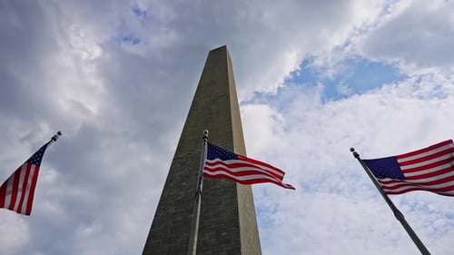 Washington Monument with American Flags waving in wind