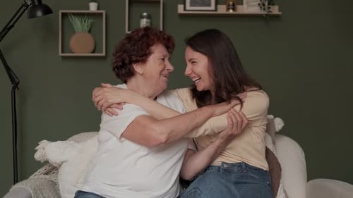 Smiling Woman and Senior Woman Laughing and Embracing