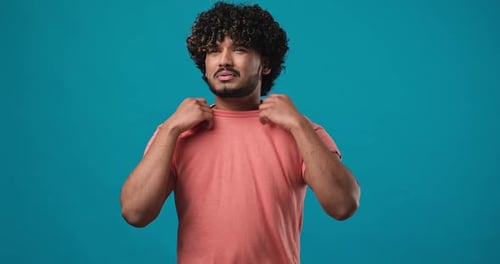 Tired Indian Bearded Man Suffering Due to Extreme Heat and Stuffiness Fans Himself Standing Isolated