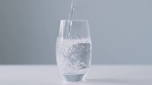 Water Pouring Into a Clear Glass