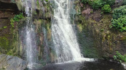 Aerial drone footage of a tall rocky waterfall in the Yorkshire Dales, Pennies. Moorland scene of a